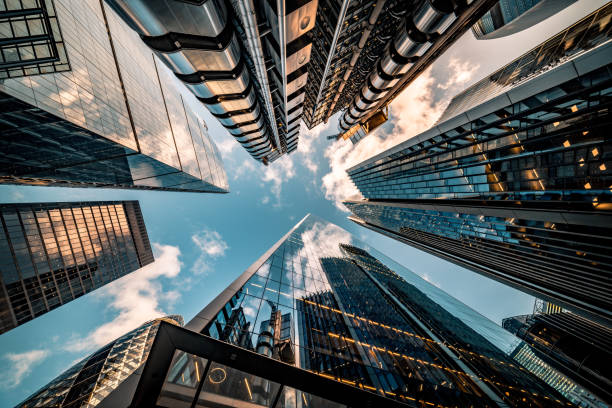 gettyimages-1215119911-612x612 Highly detailed abstract wide angle view up towards the sky in the financial district of London City and its ultra modern contemporary buildings with unique architecture. Shot on Canon EOS R full frame with 10mm wide angle lens. Image is ideal for background.